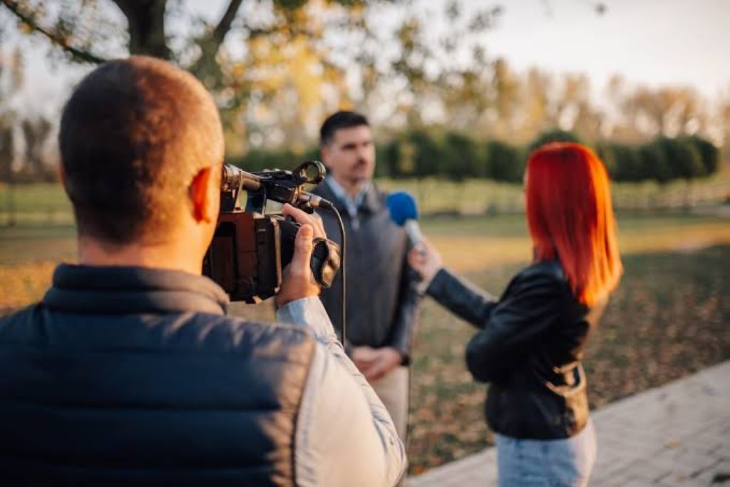Business owner speaking with journalists to secure media coverage and publicity
