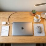 Minimalist small desk organized with a compact laptop, sleek lamp, and tidy stationery holder.
